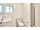 Bright bathroom with a single sink vanity, toilet and shower at 901 King St, Denver, CO 80204