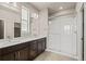 Well-lit bathroom featuring a double vanity and a glass enclosed shower at 20871 E 60Th Ave, Aurora, CO 80019