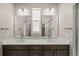 Bright bathroom with a double sink vanity and large mirrors at 20871 E 60Th Ave, Aurora, CO 80019