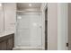 Shower with glass door, seat and white tiled walls, alongside a modern vanity at 20871 E 60Th Ave, Aurora, CO 80019