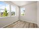 Bright bedroom with three windows, neutral walls and wood flooring at 20871 E 60Th Ave, Aurora, CO 80019