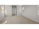 Spacious bedroom with carpet, white walls, and a doorway to another room at 20871 E 60Th Ave, Aurora, CO 80019