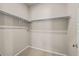 Walk-in closet featuring built in shelving and neutral carpeting at 20871 E 60Th Ave, Aurora, CO 80019