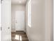 Bright entryway features wood flooring, a white front door with sidelight and neutral walls at 20871 E 60Th Ave, Aurora, CO 80019