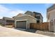 Exterior view of the home featuring an attached garage and fenced yard at 20871 E 60Th Ave, Aurora, CO 80019