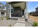 Inviting front porch featuring stylish stone accents and covered entryway at 20871 E 60Th Ave, Aurora, CO 80019