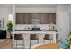 Bright kitchen with a large island and breakfast bar, stainless steel appliances and warm brown wood cabinets at 20871 E 60Th Ave, Aurora, CO 80019
