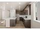 Bright kitchen featuring an island, stainless appliances, and dark wood cabinetry, offering ample storage space at 20871 E 60Th Ave, Aurora, CO 80019