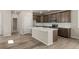 Beautiful kitchen featuring sleek cabinets, stainless appliances, and a modern island with seating at 20871 E 60Th Ave, Aurora, CO 80019