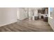 Bright and spacious living room featuring wood floors open to the kitchen with a large island and stainless appliances at 20871 E 60Th Ave, Aurora, CO 80019