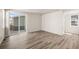 Spacious living area with sliding glass door, hardwood floors, and natural light, perfect for relaxation and entertaining at 20871 E 60Th Ave, Aurora, CO 80019