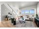Spacious living room with modern furnishings, large windows, and hardwood floors at 20871 E 60Th Ave, Aurora, CO 80019