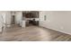 Open-concept living space with modern kitchen, wood floors, and ample natural light, creating a vibrant home at 20871 E 60Th Ave, Aurora, CO 80019