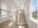 Bright stairway with carpeted steps and white banister at 20871 E 60Th Ave, Aurora, CO 80019