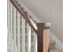 Close-up of staircase railing with dark wood handrail and white spindles at 20871 E 60Th Ave, Aurora, CO 80019