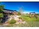 A sprawling backyard with a patio and swing set under a blue sky at 6191 S Olathe St, Centennial, CO 80016