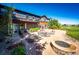 A stone fire pit and patio furniture are focal points of backyard at 6191 S Olathe St, Centennial, CO 80016