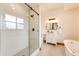 Elegant bathroom featuring a walk-in shower, modern vanity, and a luxurious soaking tub at 6191 S Olathe St, Centennial, CO 80016