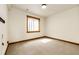 A carpeted bedroom with a window well allowing natural light at 6191 S Olathe St, Centennial, CO 80016