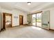 Bright, neutral bedroom space features sliding door to outdoor area with built-in storage at 6191 S Olathe St, Centennial, CO 80016