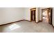 A carpeted bedroom with a shelved closet and views of other rooms at 6191 S Olathe St, Centennial, CO 80016