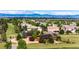 Expansive real estate with lush green lawns, mature trees, and mountain views on the horizon at 6191 S Olathe St, Centennial, CO 80016