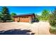 Close up of a detached four car garage with wood doors and stone accents at 6191 S Olathe St, Centennial, CO 80016