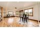 Open living area with hardwood floors, large windows, and a stylish dining area with bar seating at 6191 S Olathe St, Centennial, CO 80016