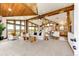 Bright living room with vaulted ceilings, wood beams, a fireplace, and abundant natural light at 6191 S Olathe St, Centennial, CO 80016
