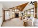 Inviting living room with a cozy fireplace, vaulted ceilings, and plenty of natural light at 6191 S Olathe St, Centennial, CO 80016
