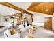 Bright open concept living space with vaulted ceilings, wood beams, and neutral finishes at 6191 S Olathe St, Centennial, CO 80016
