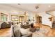 Spacious living room with hardwood floors, stylish furniture, and natural light streaming through large windows at 6191 S Olathe St, Centennial, CO 80016