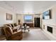 Cozy living room featuring a fireplace, large windows, and comfortable seating at 1020 15Th St # 42A, Denver, CO 80202