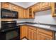 Bright kitchen features wood cabinets, black appliances and tile flooring at 1020 15Th St # 15G, Denver, CO 80202