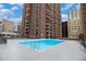 Rooftop swimming pool surrounded by high-rise buildings offering a relaxing urban oasis at 1020 15Th St # 15G, Denver, CO 80202