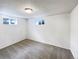 Basement with neutral carpet, white walls, and two windows providing natural light at 945 W 8Th Avenue Dr, Broomfield, CO 80020