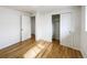 Bedroom with hardwood floors, closet, and white painted doors at 945 W 8Th Avenue Dr, Broomfield, CO 80020