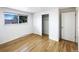 Bedroom featuring a closet, hardwood floors, and a sunny window at 945 W 8Th Avenue Dr, Broomfield, CO 80020