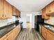 Traditional kitchen with wood cabinets, updated black appliances and sleek countertop at 945 W 8Th Avenue Dr, Broomfield, CO 80020