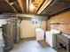 A basement laundry room with washer, dryer, utility sink, and exposed plumbing at 945 W 8Th Avenue Dr, Broomfield, CO 80020