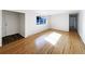 Light-filled living room with hardwood floors, a large window, and neutral-colored walls at 945 W 8Th Avenue Dr, Broomfield, CO 80020