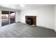 Cozy living room featuring a fireplace and sliding door to the deck at 945 W 8Th Avenue Dr, Broomfield, CO 80020