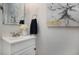 Cozy half bathroom with a sink, mirror, and neutral decor at 17233 E Princeton Dr, Aurora, CO 80013