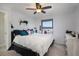 Bright bedroom with large window, ceiling fan, and neutral decor at 17233 E Princeton Dr, Aurora, CO 80013