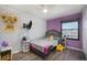 Kid-friendly bedroom with a lion-themed wall hanging at 17233 E Princeton Dr, Aurora, CO 80013