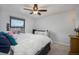 Comfortable bedroom features a ceiling fan and large window at 17233 E Princeton Dr, Aurora, CO 80013