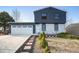 Charming home featuring a two-car garage, inviting brick walkway, and manicured landscaping at 17233 E Princeton Dr, Aurora, CO 80013