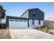 Inviting home featuring an attached two car garage and a long concrete driveway at 17233 E Princeton Dr, Aurora, CO 80013