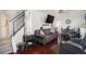 Cozy living room featuring hardwood floors, a comfortable sofa, and a modern television at 17233 E Princeton Dr, Aurora, CO 80013