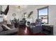 Inviting living room with hardwood floors, a fireplace, and comfortable leather seating at 17233 E Princeton Dr, Aurora, CO 80013